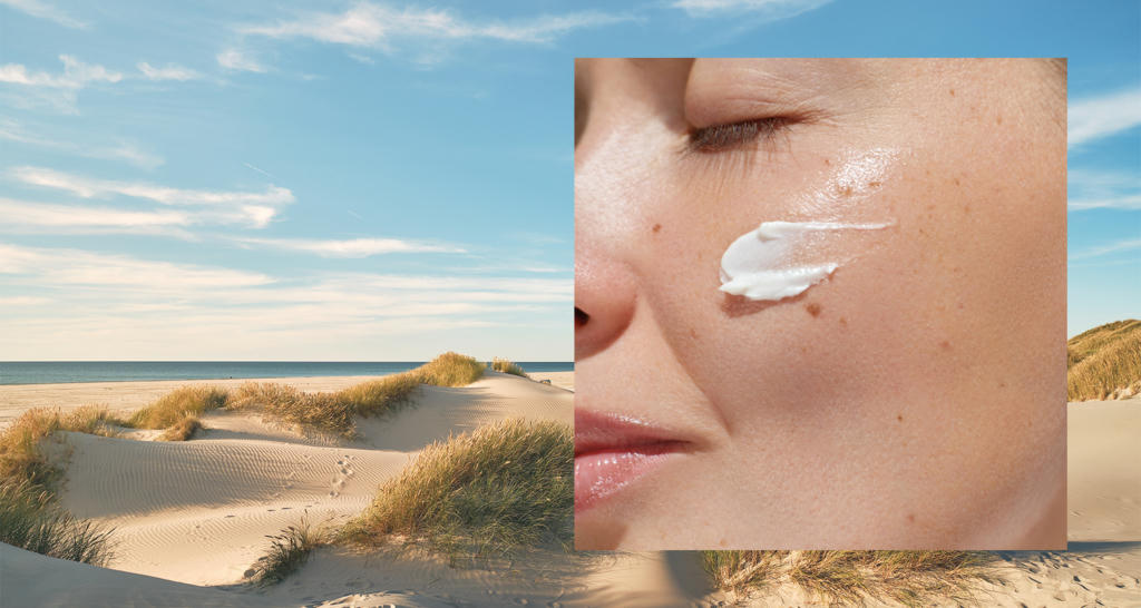 Beach, sun and sand. A woman with sunscreen applied on her cheek.